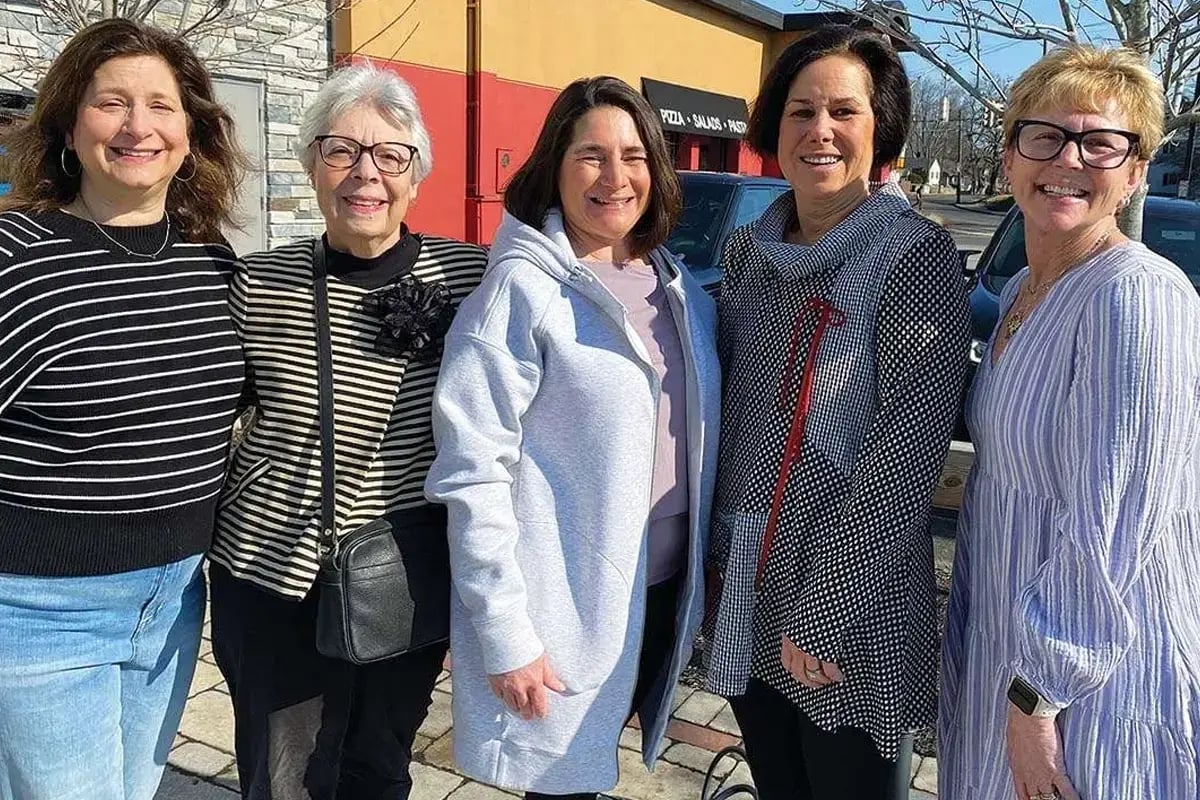 Women of different ages standing together