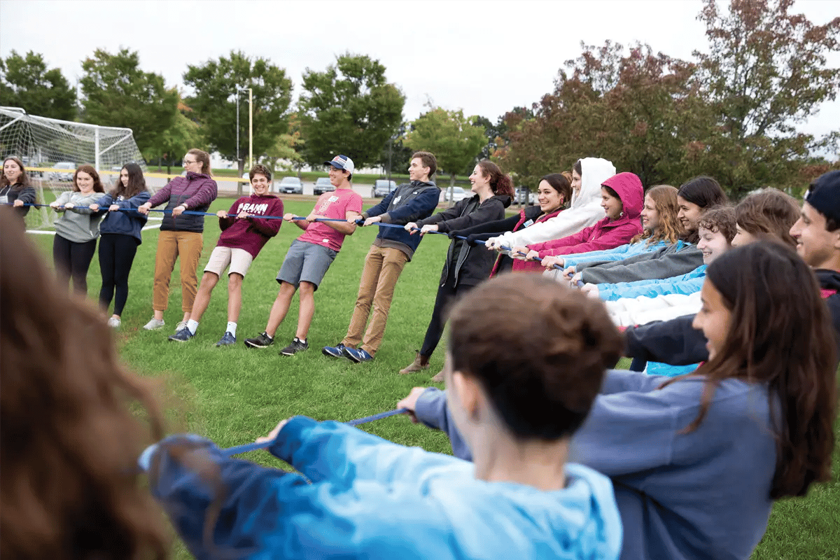 Jewish children and teens standing together in a circle during a community youth program
