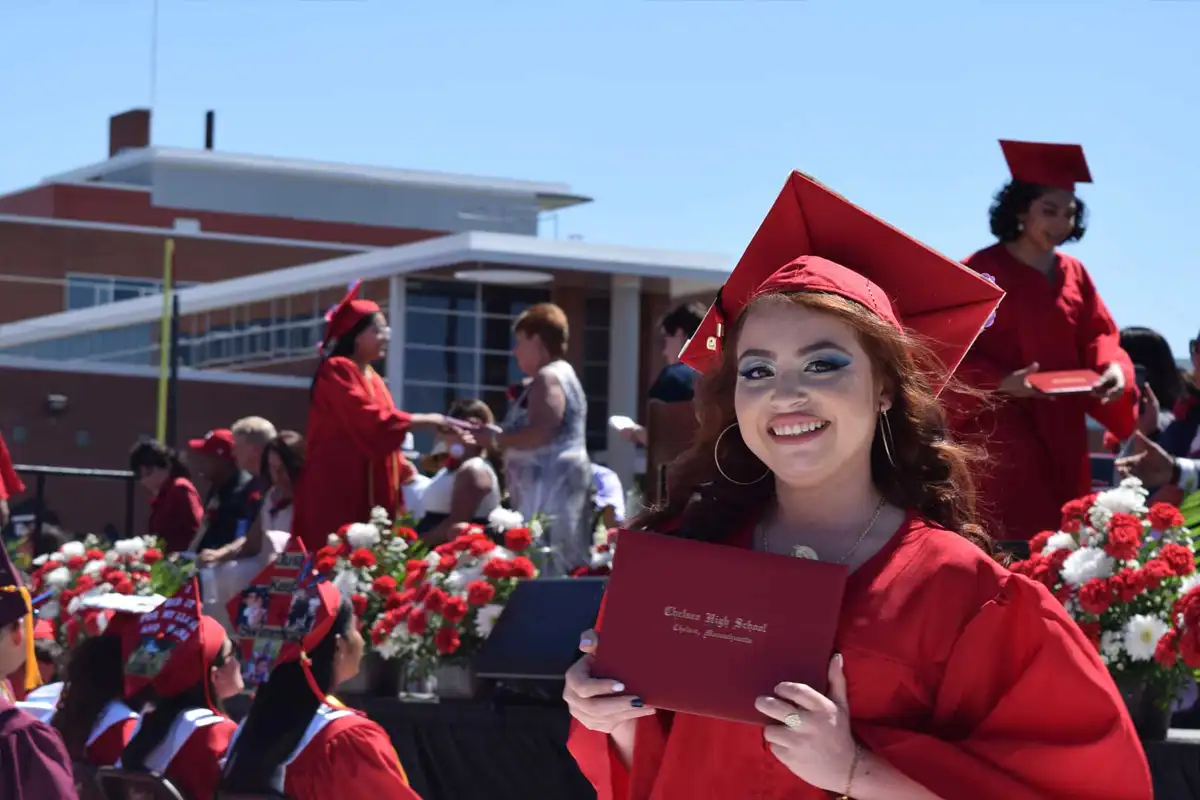 Young woman in a red cap and gown at graduation